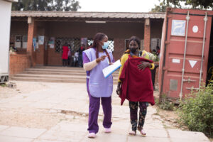 mothers2mothers Mentor Mother walking with her client outside Chipata Hospital in Zambia.