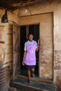 Hanifah, m2m Mentor Mother, outside her home in Uganda.