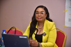 A photo of Chinyerem Immanuel, m2m Nigeria Country Director, at a desk