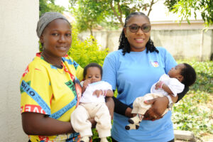 Mentor Mother Grace (on the left) with a client and her twin babies